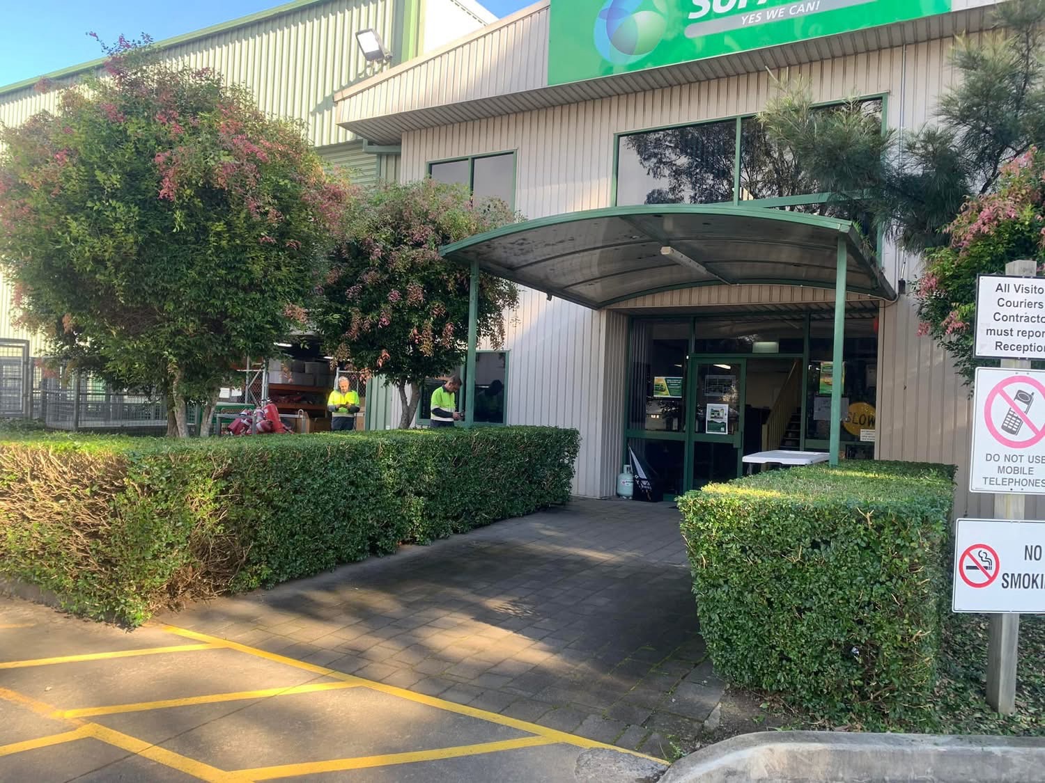 Maintained hedges and planting at a workplace entrance